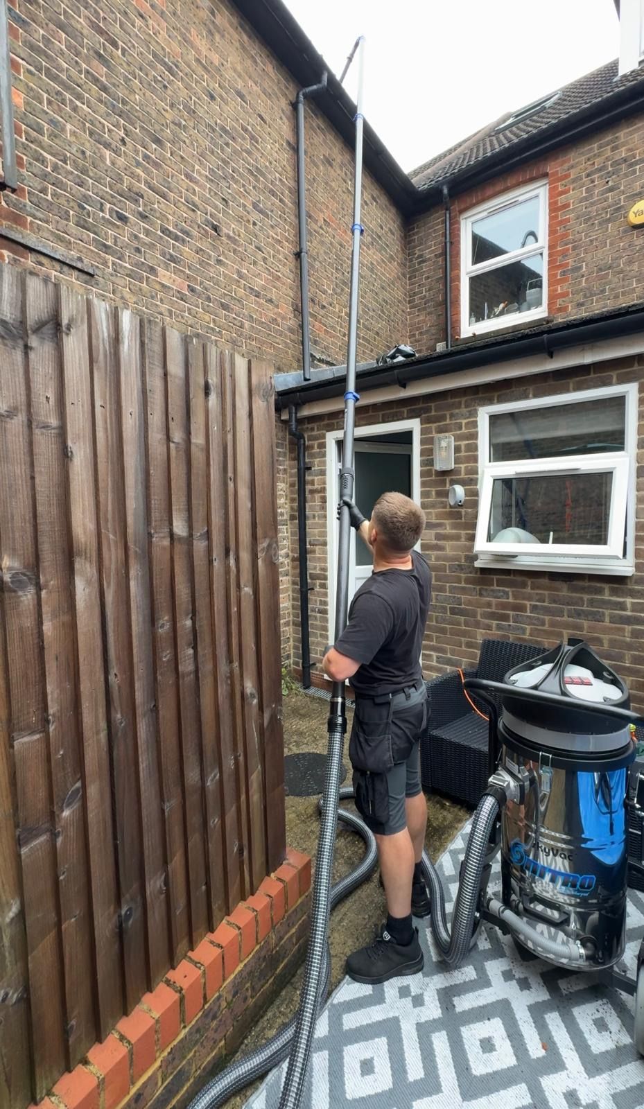 High-reach gutter vacuum machine clearing a gutter in Croydon
